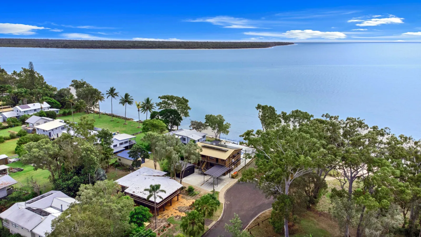 Aerial view across the water beside the Burrum Heads oceanfront units