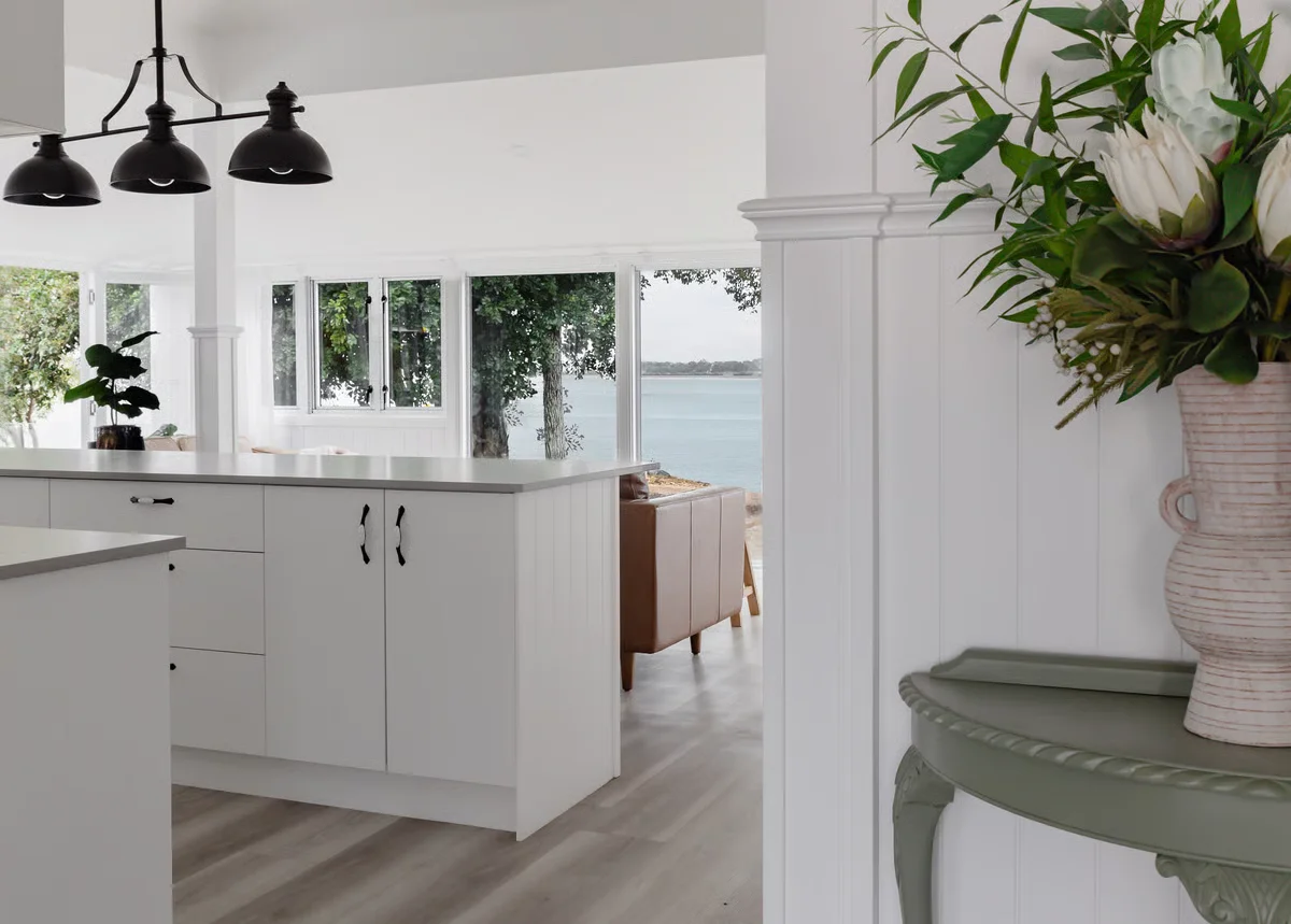 Sunset Waters kitchen with white cabinetry and black pendant lights