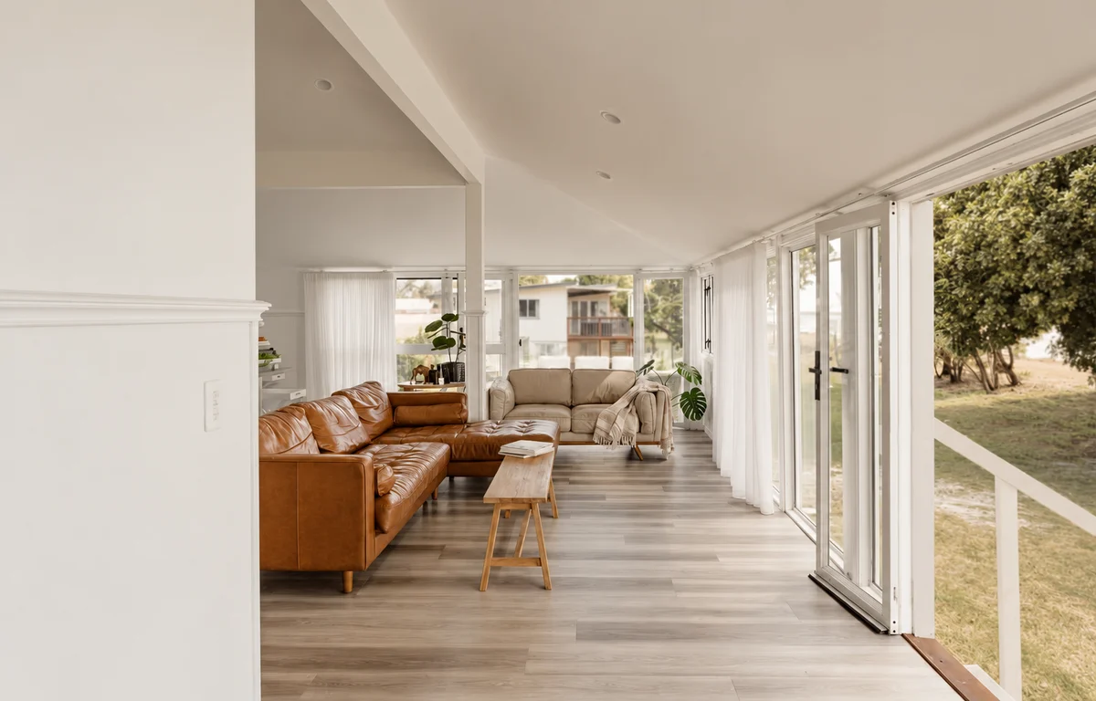 Sunset Waters lounge with leather sofas and garden-facing windows