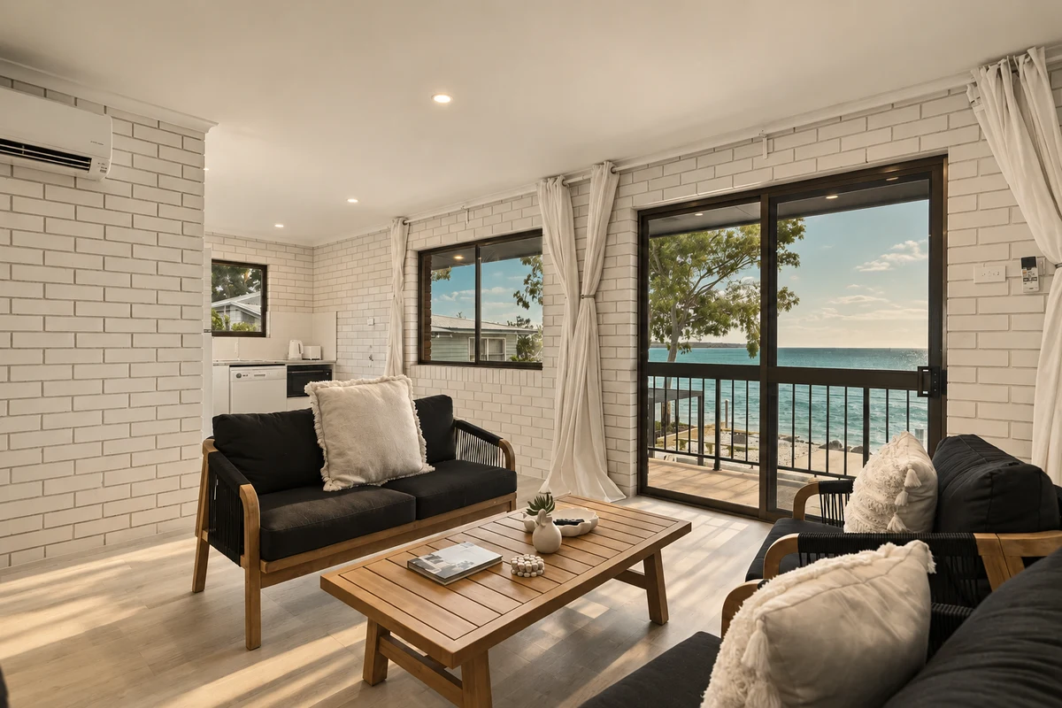 Oceanfront unit living room opening to a private balcony with water views