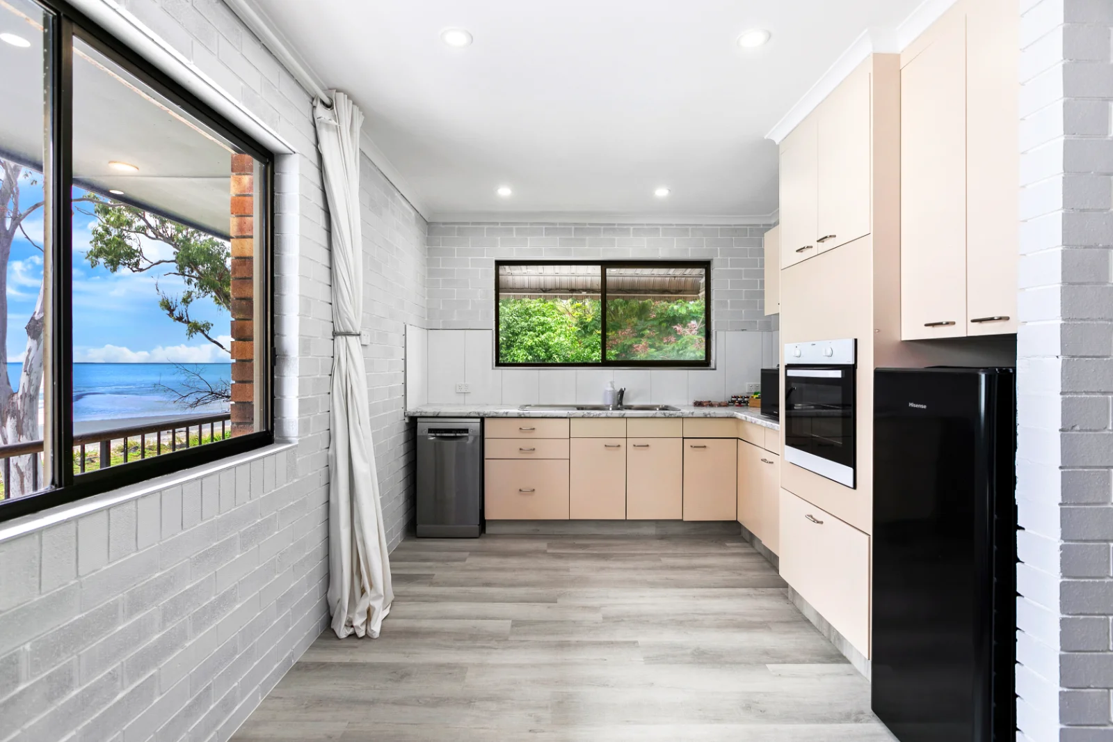 Oceanfront unit kitchen with full-size appliances and a timber benchtop
